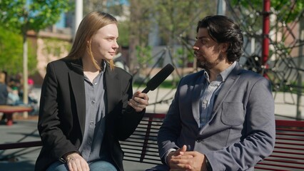 Outdoor interview in the park: Reporter Discusses with Local Expert