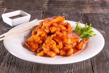 Sweet and Sour Chicken on wood table. Chinese food.