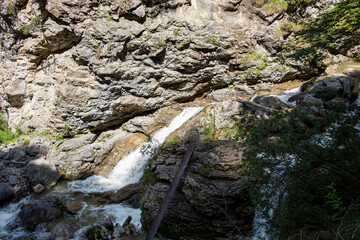 water flowing through pebbles in stream