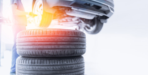 Closeup wheel of car in garage. Banner professional mechanic changing tires.