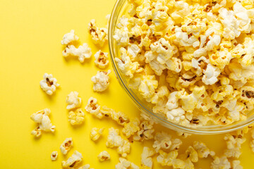Salty popcorn on bright color background. Cinema and entertainment concept. Movie night with popcorn. Delicious appetizer, snack.Space for text, copy space. Banner