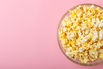 Salty popcorn on bright color background. Cinema and entertainment concept. Movie night with popcorn. Delicious appetizer, snack.Space for text, copy space. Banner