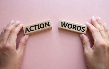 Action or words symbol. Concept word Action or words on wooden blocks. Businessman hand. Beautiful pink background. Business and Action or words concept. Copy space