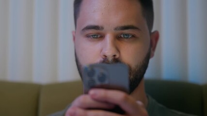 Close up face Caucasian man play video gaming addict glued mobile phone smartphone cellphone digital device guy male tech watching network cyberspace wireless social web bedroom bed night user connect