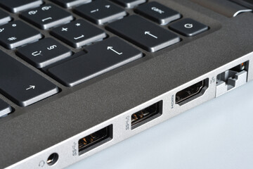 Detail of headphone jacks, usb ports, hdmi and rj45 lan port on the side of a modern laptop