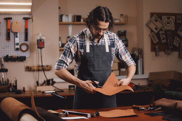 Tailor use tools for maker from natural leather product brown color in workshop. Concept shoemaker industry business