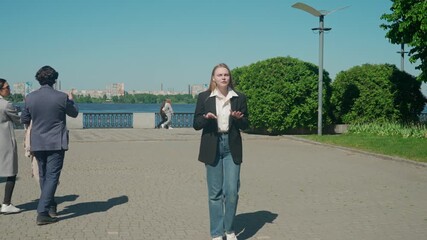 A reporter broadcasts live outdoors on the embankment