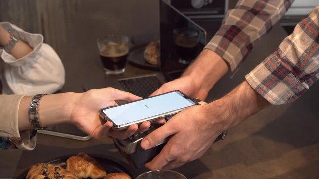 Close up of hand to usine mobile scane and payment coffee