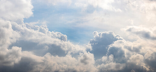 Bright sunlit white curly clouds on a fine day