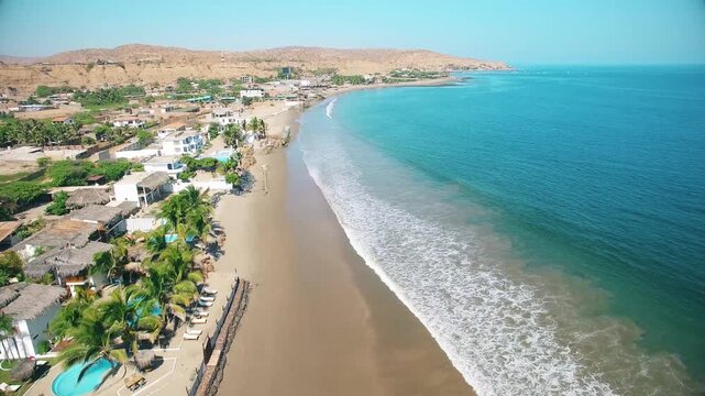  Stunning aerial shot of M&aacute;ncora, Peru, showcasing the vibrant blue waters of the Pacific Ocean in ultra-high-definition 4K at 60 frames per second. The image captures the beauty of this popula