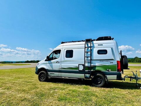 camper van on the road The beautiful camper van, Winnebago 4&times;4 Revel, on the road. It costs as much as house ($210,292 base price) - motorhomes