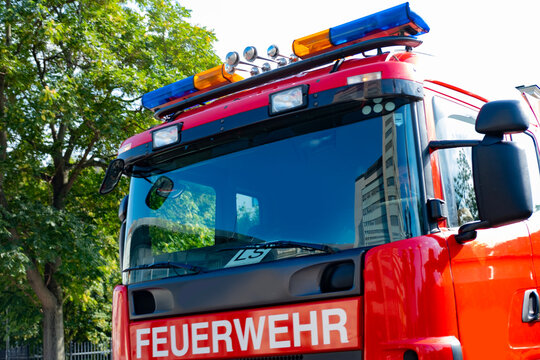 Austrian fire engines on street, inscription in German fire department, highlighting emergency readiness in urban environment, emergency services 122, Vienna, Austria