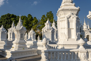 Obraz premium a grouping of whitewashed mausoleums, which house the cremation ashes of members of the royal family of Chiang Mai in Wat Suan Dok, Chiang Mai, Thailand