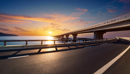 Fototapeta premium bridge and asphalt highway at dusk near the ocean