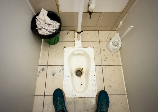 Dirty toilet in public restroom. Man urinating. Dirty toilet bowl. Peeing to toilet bowl in Public toiletroom. Man Standing peeing in a bowl. Urinating, peeing, pee, pissing in wc.