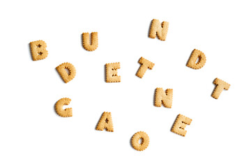 alphabet made from cookies in discord on a white background. Interesting spelling with crackers