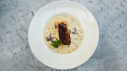 Rigatoni Carbonara Pasta with Crispy Bacon Served in Creamy White Sauce on Marble Table