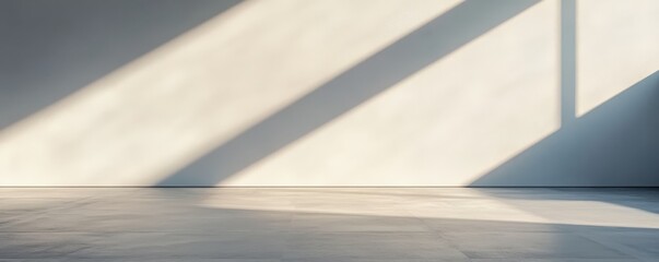 Empty room with sunlight casting long shadows on the floor. Minimalist interior, clean lines, modern architectural design.