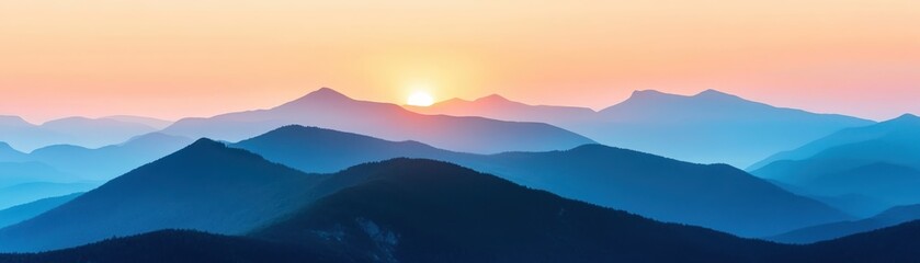 Obraz premium Serene mountain landscape at sunrise with layers of blue hills and a warm, glowing horizon. Perfect for nature, travel, and scenic themes.