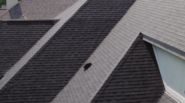 Aerial footage of element new roof is installed on a private house. Day time