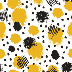 Seamless pattern with rough painted dots in black and yellow on white.
