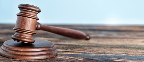 Judge's gavel on wooden table