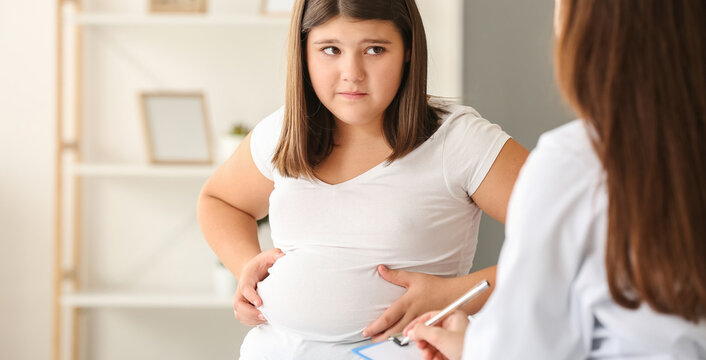 Sad overweight girl visiting nutritionist in clinic
