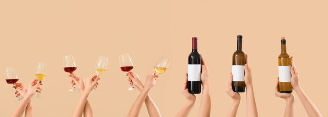 Women with bottles of wine on beige background. Valentine's Day celebration