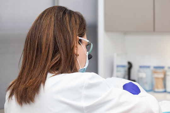 Dermatologist carrying out a skin biopsy on the face of a senior adult patient