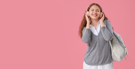 Happy female student with backpack and headphones on pink background with space for text