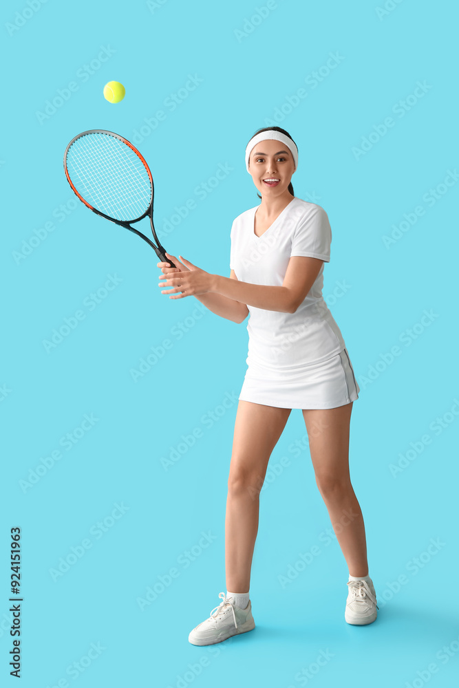 Poster Female tennis player playing with ball on blue background