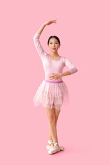 Young Asian ballerina on pink background