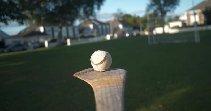 Hurling Ireland sport action player lifts balances and bounces sliotar ball on hurley stick