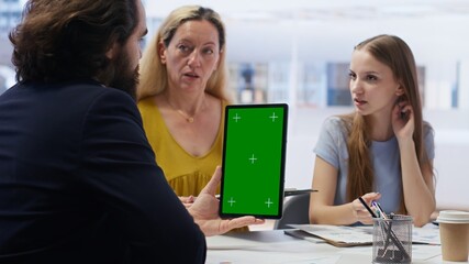 Broker holding green screen tablet, meeting with clients to provide stock exchange analysis. Financial advisor with chroma key device looking at market shares, helping family maximize income, camera B
