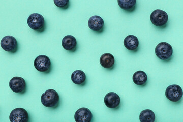 Sweet fresh blueberries on turquoise background