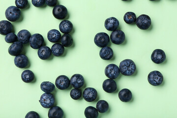 Sweet fresh blueberries on green background