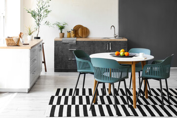 Interior of stylish room with dining table and counters