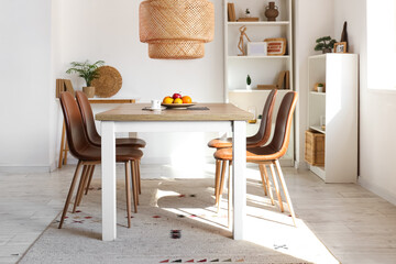 Interior of light room with dining table and shelf units