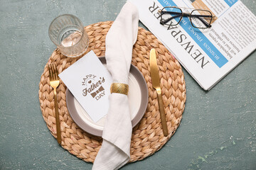 Stylish table setting with greeting card on dark blue background. Father day celebration concept