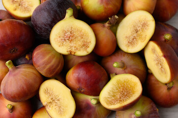A cluster of ripe figs neatly arranged side by side on a surface