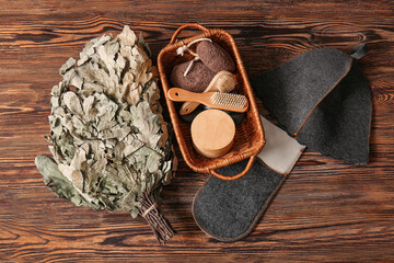 Set of accessories for sauna with oak broom on wooden background