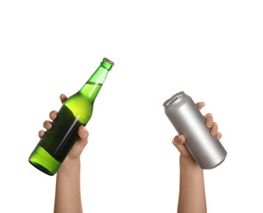 Female hand with fresh beer in bottle and can on white background