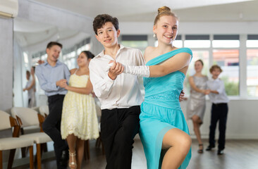 Fototapeta premium Group of festively dressed boys and girls dance a twist dance