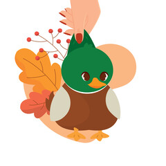 Hand holding cute autumn duck with leaves, Vector