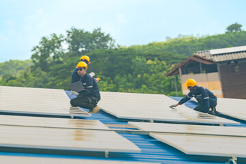 Worker Technicians are working to construct solar panels system on roof. Installing solar photovoltaic panel system. Men technicians walking on roof structure to check photovoltaic solar modules.