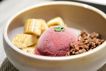 Home made Acai berry yogurt with banana, granola and dark chocolate, Healthy dessert bowl, tasty superfood