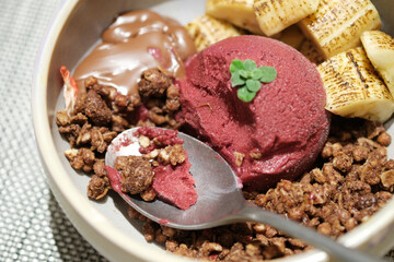 Home made Acai berry yogurt with banana, granola and dark chocolate, Healthy dessert bowl, tasty superfood