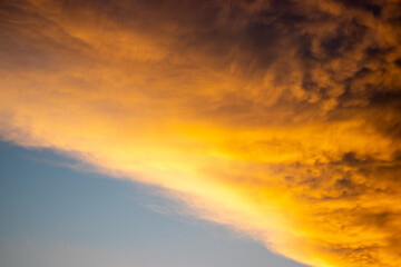Vivid sunset clouds with warm hues, perfect for backgrounds with text space, symbolizing hope and renewal.