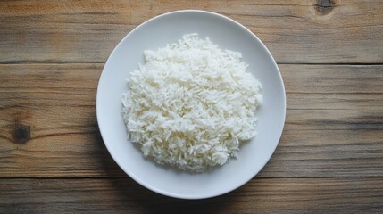 Cooked Jasmine rice served on a white plate, placed on a wooden table, ready to be enjoyed. Minimalistic and inviting food concept.
