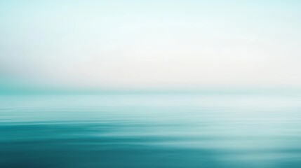 Obraz premium Blurred background depicting a turquoise water surface merging with a pale sky, perfect for minimalist designs and concepts related to nature and serenity